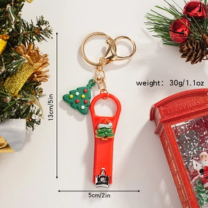 Detailed view of red Christmas tree nail clipper keychain with dimensions 5x2 inch