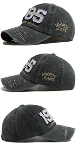 Close-up of vintage charcoal cotton baseball cap with 85 embroidery and distressed edges