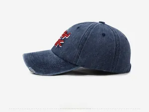 Detail of New York embroidery on washed denim baseball cap with distressed brim
