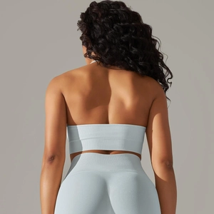 Detail of light blue seamless ribbed yoga set showing fabric texture and open back design