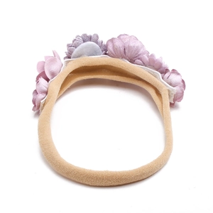 Macro shot of purple fabric flowers and pink elastic nylon headband for babies