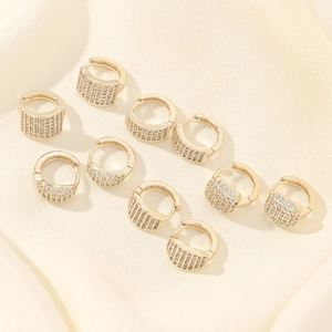 Set of five pairs of 14K gold plated huggie earrings with shimmering cubic zirconia accents