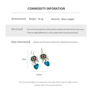 Detail view of ethnic glass bead flower earrings with 6cm height and 2.5cm width dimensions