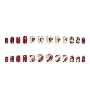Christmas press-on nails set with Santa gnome, red glitter and festive stripe patterns