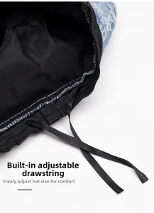 Detail of adjustable inner drawstring for denim bucket hat with black fabric lining