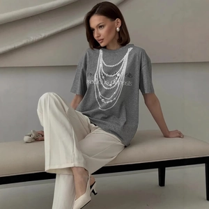 Detail of grey cotton T-shirt featuring pearl necklace print and lettering on model
