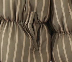 Detail of army green striped puffer coat showing elastic waist and side pocket