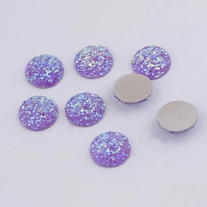 Detailed view of 14mm purple round resin cabochons with sparkling glitter and flat back