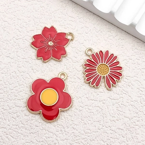 Detailed macro view of red enamel alloy flower charms for DIY jewelry and necklaces