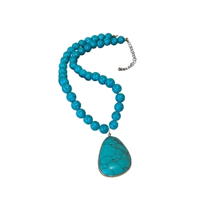 Bohemian turquoise beaded necklace with a teardrop stone pendant and silver chain