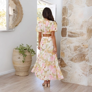 Floral two-piece set with puff sleeve crop top and long skirt featuring backless design