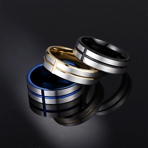 Men's stainless steel cross rings in gold, blue, and black finishes on a reflective surface