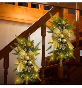 Christmas teardrop swag with golden ornaments and warm LED lights on stairs