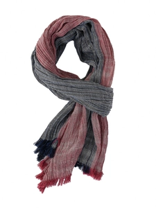 Detail of navy blue and red striped light scarf with fringe tassels and woven texture