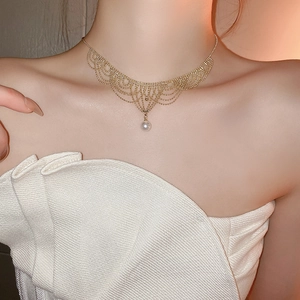 Detailed close-up of a 24K gold-plated lace mesh necklace with a single white pearl pendant