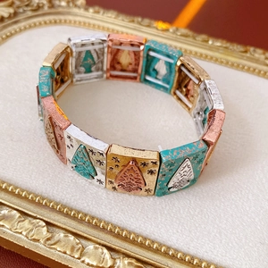 Detail of vintage embossed rectangular metal link bracelet with bohemian texture
