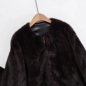 Deep brown faux fur bomber jacket with black leather collar trim and metal zipper detail