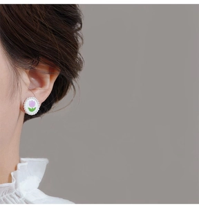 Close-up of tulip earring with pearl trim shown on ear for realistic size and fit