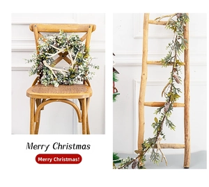 Close-up of Christmas wreath and vine with antlers, pinecones, and white berries