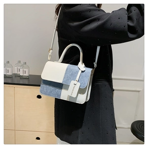 Model wearing a color-block patchwork square bag with denim and leather checkers