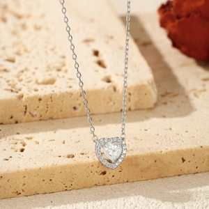 Elegant S925 sterling silver heart necklace with 0.5ct moissanite on stone background