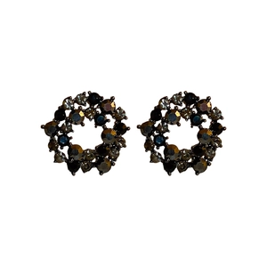 Vintage dark style circular earrings with black rhinestones on a white background