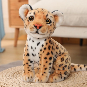 Detailed close-up of a plush leopard cub toy with realistic spots on a woven mat