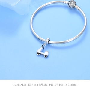 Detail of S925 silver charm bracelet with scooter pendant and 'Unique you are' engraving