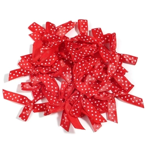 Close-up of handmade red satin ribbon bows with white polka dots for gift decoration