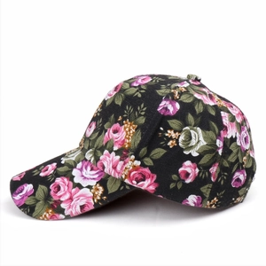 Close-up of floral print on black canvas baseball cap with pink and purple rose patterns