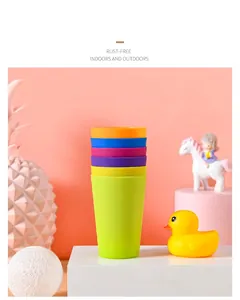 Close-up of vibrant matte plastic stacking cups set against a pink playful background