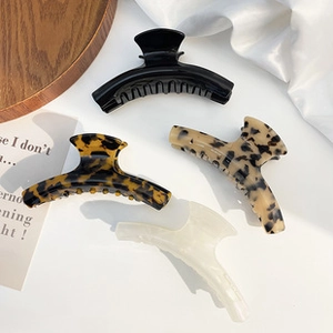 Set of four tortoiseshell and solid color cellulose acetate hair claw clips for women