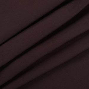 Detail of dark brown knitted fabric showing fine ribbed texture and flexible drapery