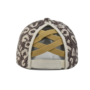 Detail view of leopard print baseball cap with elastic criss-cross ponytail hole and velcro strap