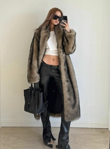Detailed texture of long brown faux fur coat with elegant shawl collar and plush finish