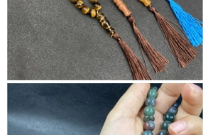 Detailed macro view of natural crystal prayer beads with decorative handmade tassels
