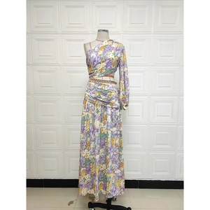 Detail view of floral one-shoulder dress with waist cutout and gold chain belt