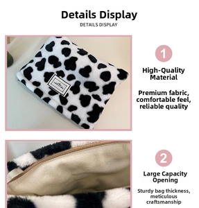Detail view of cow print plush coin purse with inner lining and zipper closure