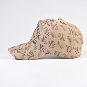 Side view of beige baseball cap with rhinestone accents and Ys fashion pattern