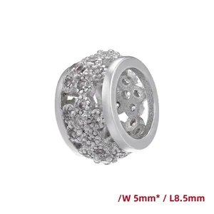 Detail view of 18K gold plated bead with hollow flower pattern and clear zircon stones