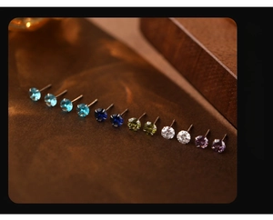 Detail of S999 silver stud earrings with multi-colored rhinestones in four-prong settings