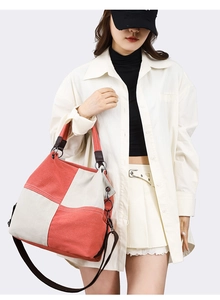 Detail of canvas tote bag with contrast stitching and adjustable shoulder strap