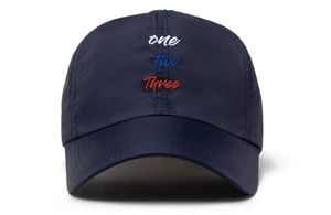 Close-up of navy mesh baseball cap featuring tricolor 'one two Three' script embroidery
