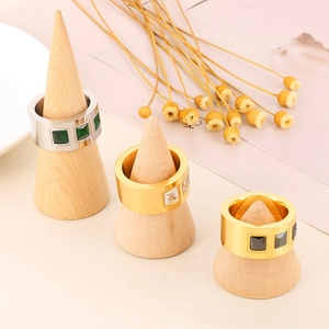 Luxury titanium steel rings with colorful zircon crystals on wooden cone stands