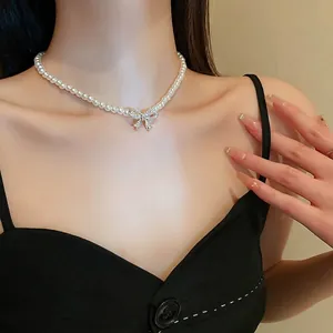 French vintage pearl necklace with a sparkling bow pendant for a delicate collarbone look