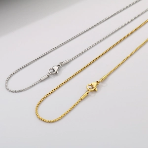 Detailed view of gold and silver stainless steel box chains with secure lobster clasps