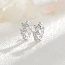 Macro shot of silver lightning bolt earrings with shimmering pavé crystal setting