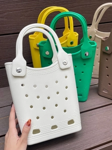 Close-up of colorful EVA beach bags with signature holes and silver metal rivets