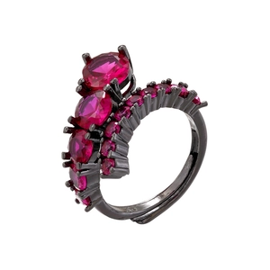 Detail view of black metal ring featuring claw-set red stones and oval gemstones
