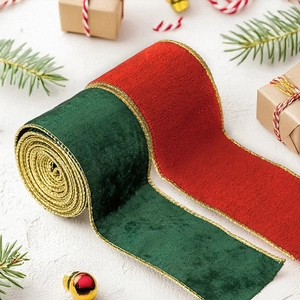 Close-up of luxury dark green and red velvet Christmas ribbons with gold wired edges